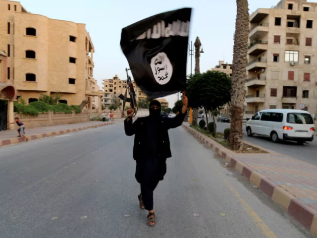 a member loyal to the islamic state in iraq and the levant isil waves an isil flag in raqqa syria june 29 2014 photo reuters a member loyal to the islamic state in iraq and the levant isil waves an isil flag in raqqa syria june 29 2014 photo reuters