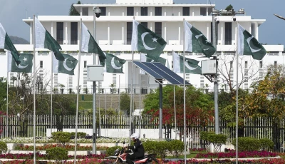 a man rides a motorcycle past the president house as pakistan gears up to host the us and iran for peace talks in islamabad on april 10 2026 photo reuters