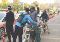 a police officer frisks a biker at a security check post along a road in islamabad photo reuters