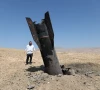 an israeli ultra orthodox jewish stands near a part of a missile protruding from the ground following strikes from iran in the central israeli occupied west bank june 8 2026 reuters