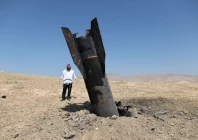 an israeli ultra orthodox jewish stands near a part of a missile protruding from the ground following strikes from iran in the central israeli occupied west bank june 8 2026 reuters