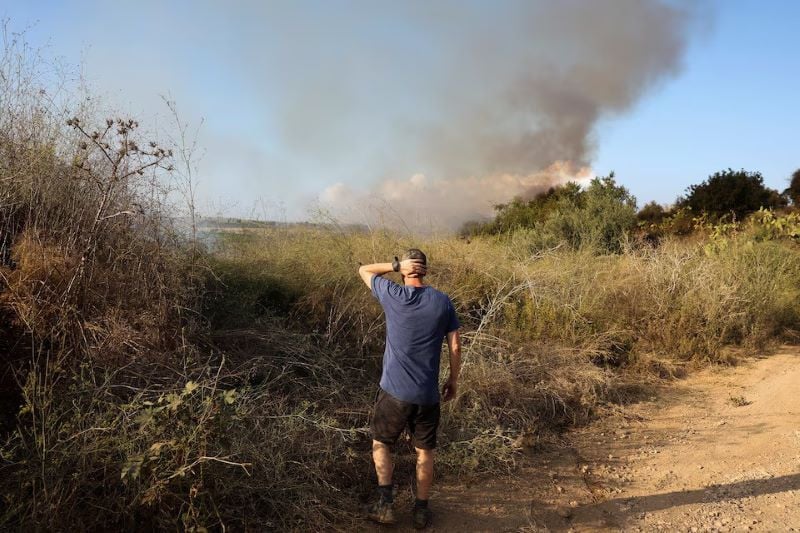 a man looks as smoke billows after a missile attack from yemen in central israel september 15 2024 photo reuters