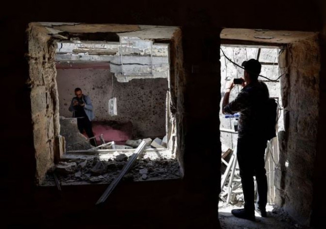 people take pictures at the site where israeli forces killed palestinian gunmen in a raid according to the israeli military in nablus in the israeli occupied west bank may 4 2023 photo reuters