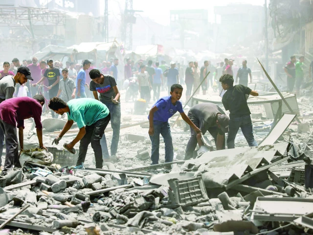 palestinians check the devastation following an israeli strike that hit gaza city s southern al zeitoun neighbourhood photo afp palestinians check the devastation following an israeli strike that hit gaza city s southern al zeitoun neighbourhood photo afp