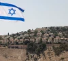 an israeli flag flutters as part of the israeli settlement of maale adumim is visible in the background the israeli occupied west bank palestine aug 14 2025 photo reuters