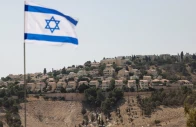 an israeli flag flutters as part of the israeli settlement of maale adumim is visible in the background the israeli occupied west bank palestine aug 14 2025 photo reuters