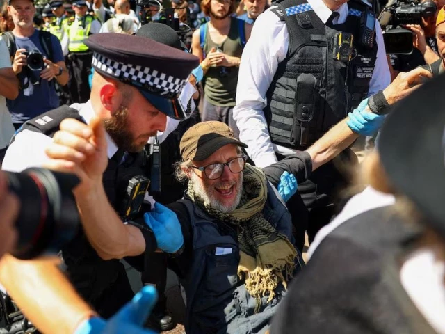 police officers carry a protester during a demonstration calling for the de proscription of the palestine action group in parliament square in london britain july 12 2025 photo reuters police officers carry a protester during a demonstration calling for the de proscription of the palestine action group in parliament square in london britain july 12 2025 photo reuters
