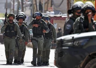 members of israeli security forces patrol along a street during a military raid in the neighbourhood of kafr aqab near ramallah in the israeli occupied west bank on january 26 2026 photo afp