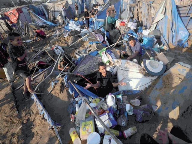 humanitarian crisis a displaced palestinian reacts as he sits on the sand amongst the remains of his tent home following an israeli airstrike that targeted the nearby medical supplies and pharmaceuticals warehouse of al aqsa martyrs hospital in deir al balah central gaza strip photo afp humanitarian crisis a displaced palestinian reacts as he sits on the sand amongst the remains of his tent home following an israeli airstrike that targeted the nearby medical supplies and pharmaceuticals warehouse of al aqsa martyrs hospital in deir al balah central gaza strip photo afp