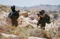 an israeli troop aims his weapon during a protest against a settlement near hebron in the israeli occupied west bank june 9 2026 reuters