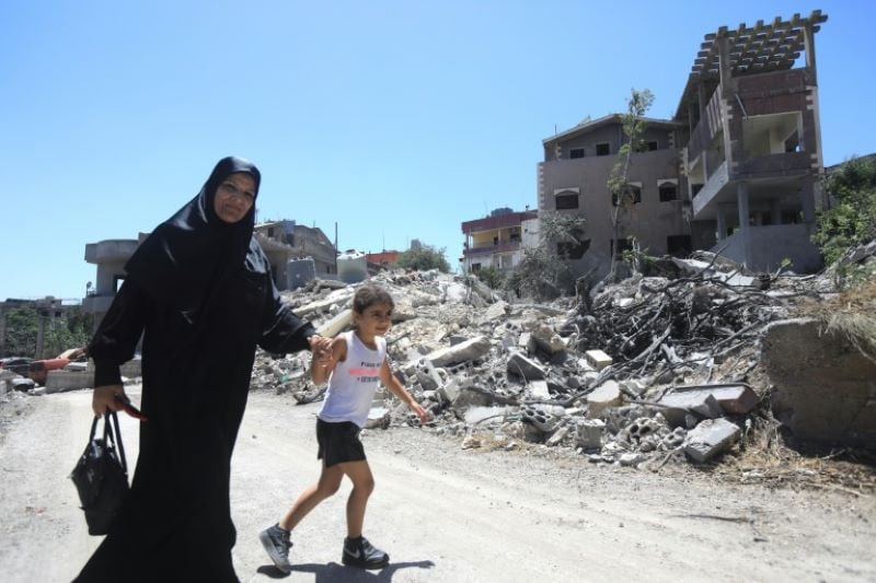 people search through the rubble following an israeli raid in southern gaza s al mawasi area photo afp