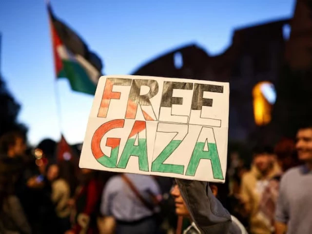 a pro palestinian protester holds a banner reading free gaza in front of the colosseum during a protest to stand in solidarity with people of gaza in rome photo reuters a pro palestinian protester holds a banner reading free gaza in front of the colosseum during a protest to stand in solidarity with people of gaza in rome photo reuters