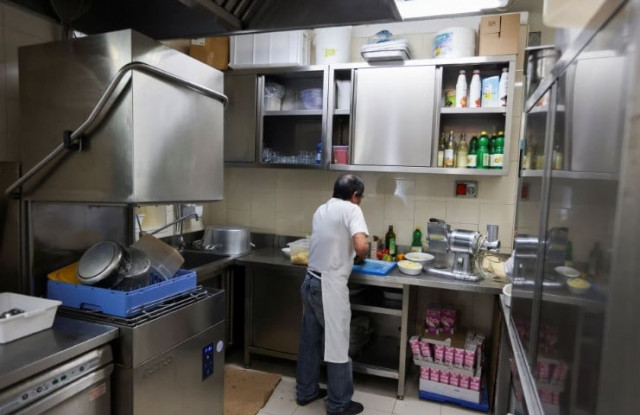 a migrant worker prepares food ar a restaurant prior to lunch time in milan italy april 26 2023 reuters claudia greco a migrant worker prepares food ar a restaurant prior to lunch time in milan italy april 26 2023 reuters claudia greco