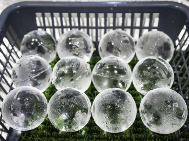 Workers haul large blocks of ice across the factory floor, before starting on the delicate work of carving perfect spheres, cubes and rectangular blocks with cut corners. PHOTO: AFP