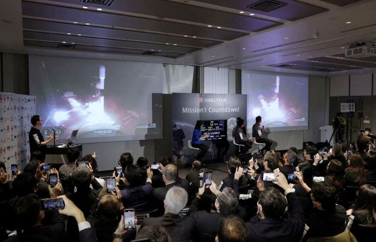 officials of ispace inc s hakuto r mission look at live broadcasting of the launch of a spacex falcon 9 rocket for ispace at cape canaveral space force station in tokyo japan december 11 2022 photo reuters