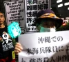 demonstrators hold placards during a protest outside foreign ministry building following the killing of a japanese woman in okinawa for which a us marine is a suspect in tokyo japan october 8 2026 reuters