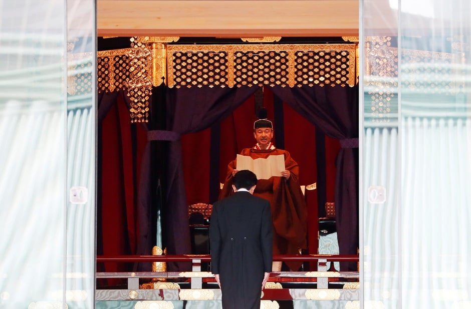 Japan's Emperor Naruhito speaks as Prime Minister Shinzo Abe is seen during a ceremony to proclaim his enthronement to the world, called Sokuirei-Seiden-no-gi. PHOTO: Reuters