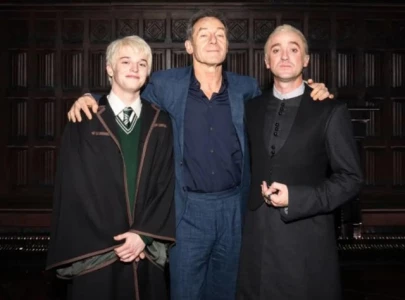 jason isaacs and tom felton share rare father son moment backstage