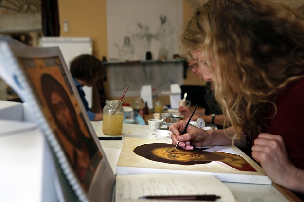 Foreign students of the Bethlehem Icon Center work on their painting during their course, in the biblical West Bank city of Bethlehem on April 11, 2017. PHOTO: AFP