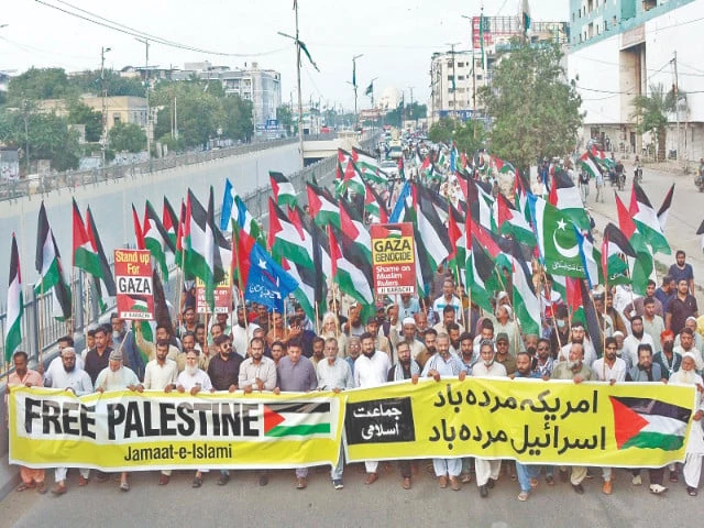 a large crowd of protesters carrying palestinian flags march through ma jinnah road raising slogans against israeli aggression in gaza photo jalal qureshi express