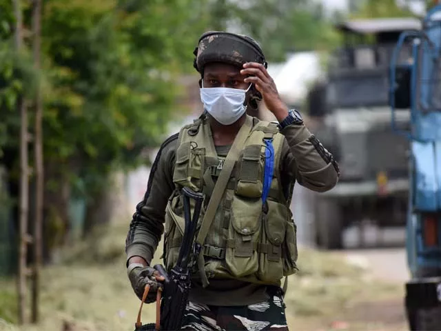 an indian soldier walks near the site of gun battle in south kashmir s shopian photo afp an indian soldier walks near the site of gun battle in south kashmir s shopian photo afp