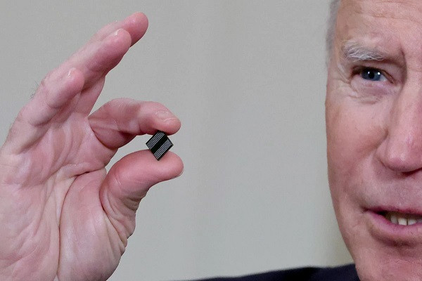 us president joe biden delivers holds a semiconductor chip as he speaks prior to signing an executive order aimed at addressing a global semiconductor chip shortage in the state dining room at the white house in washington us february 24 2021 photo reuters