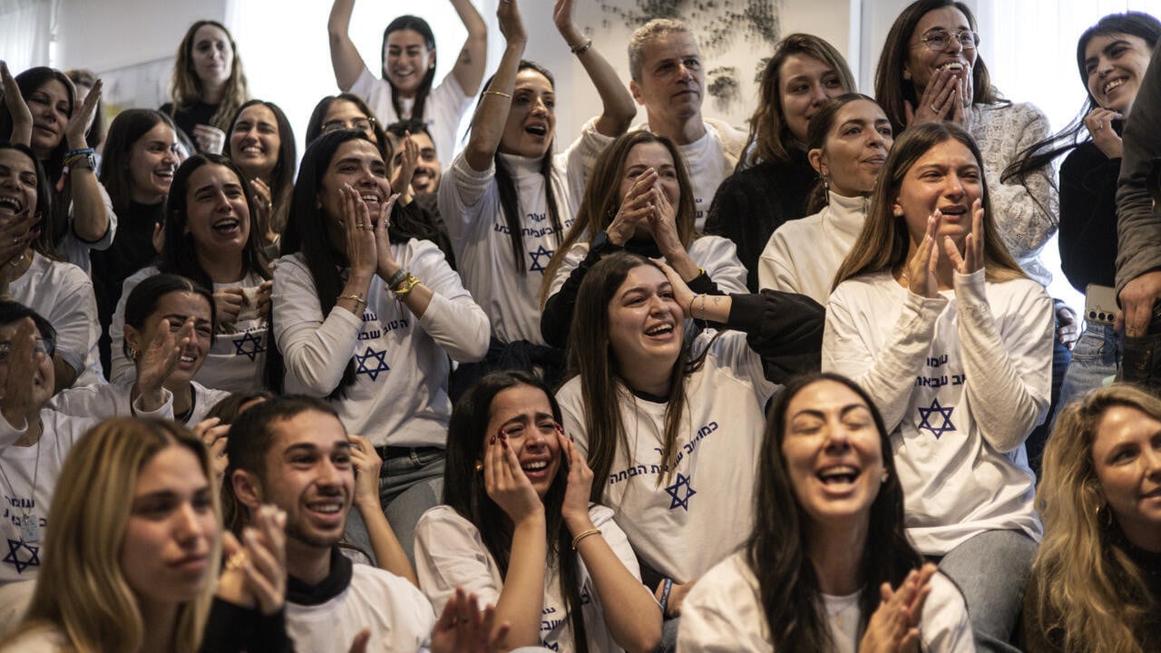 friends and family of israeli hostage omer shem tov celebrate as they watch his televised release by hamas at his family home in tel aviv photo afp