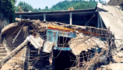 a man sits next to damaged houses following heavy rain and floods in buner district in khyber pakhtunkhwa province pakistan august 16 2025 photo reuters