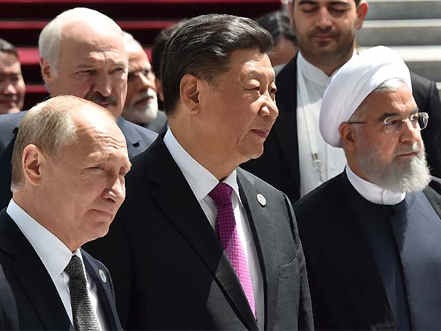 vladimir putin xi jinping and hassan rouhani walk as they attend a meeting photo afp