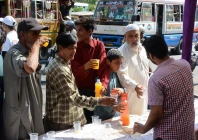 civility volunteers distribute sherbet at a stall on karachi s shahrae faisal photo jalal qureshi express