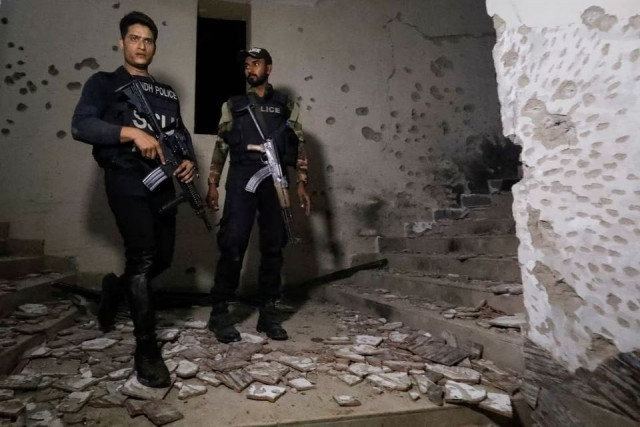 police officers stand in the aftermath of an attack on a police station photo reuters file