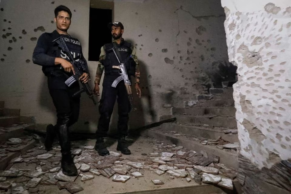 police officers stand in the aftermath of an attack on a police station in karachi february 17 2023 photo reuters