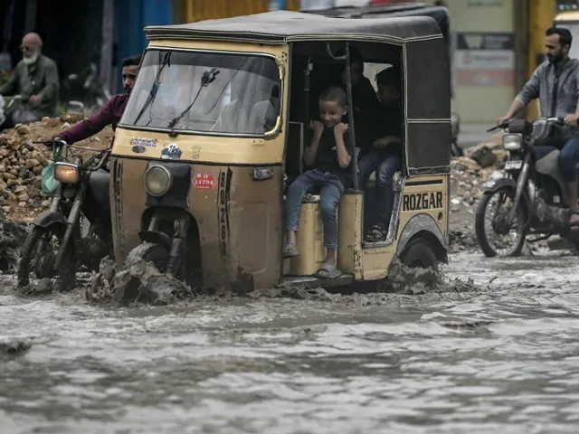 commuters make their way through a flooded street after heavy rainfall in karachi on june 28 2025 photo afp commuters make their way through a flooded street after heavy rainfall in karachi on june 28 2025 photo afp