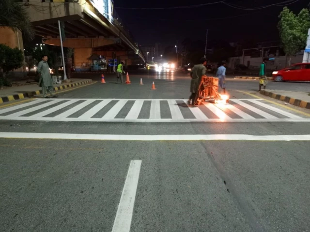 concerned agencies are installing signboards and road markings for better traffic management in karachi photo author