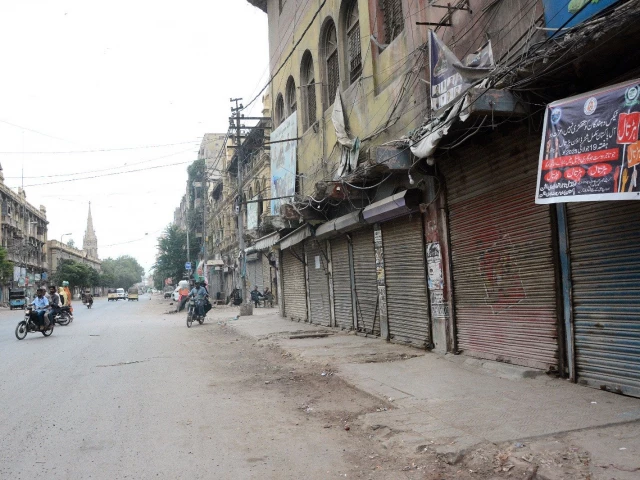 a commercial street in karachi wears a deserted look as traders observe a strike in protest against the government s tax measures photo jalal qureshi express