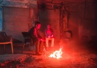 as the night s chill sets in men gather around a fire seeking warmth and comfort the flickering flames offer not just heat but a brief moment of togetherness in the cold hours photo express