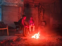 as the night s chill sets in men gather around a fire seeking warmth and comfort the flickering flames offer not just heat but a brief moment of togetherness in the cold hours photo express