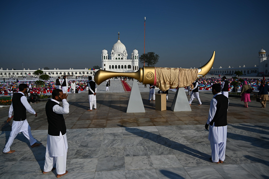 Pakistani plainclothes security officials stand guard near the inauguration site of the Shrine of Baba Guru Nanak Dev at Gurdwara Darbar Sahib in Kartarpur, near the Indian border, on November 9, 2019. PHOTO: AFP