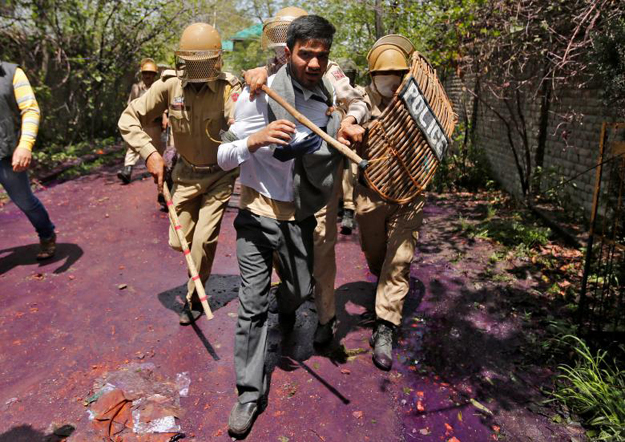 Indian policemen detain a Kashmiri student during a protest in Srinagar on April 24, 2017. PHOTO: Reuters 