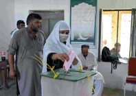 suffragette a woman casts her ballot at a polling station during the first phase of the elections in mirpur photo afp