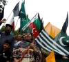people chant slogans and carry azad kashmir s flag to observe black day during a protest in karachi on august 15 2019 photo reuters