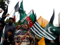 people chant slogans and carry azad kashmir s flag to observe black day during a protest in karachi on august 15 2019 photo reuters
