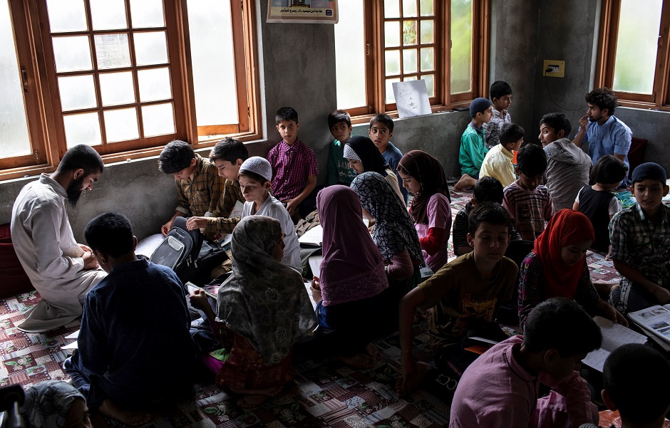Kashmiri college students teach children inside a house in Anchar neighbourhood. PHOTO: REUTERS