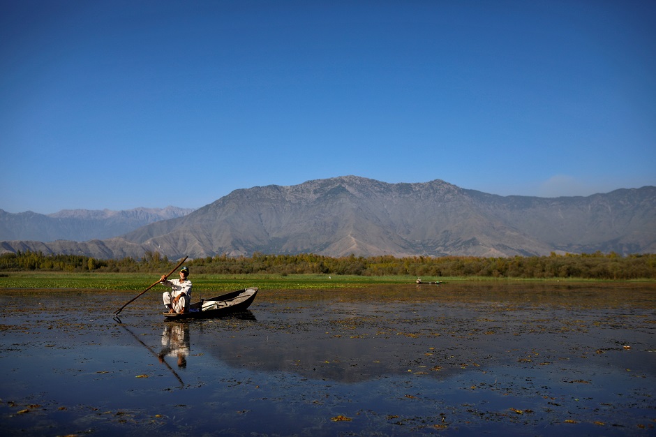 A Kashmiri man from Anchar neighbourhood catches fish in the waters of Anchar Lake. PHOTO: REUTERS