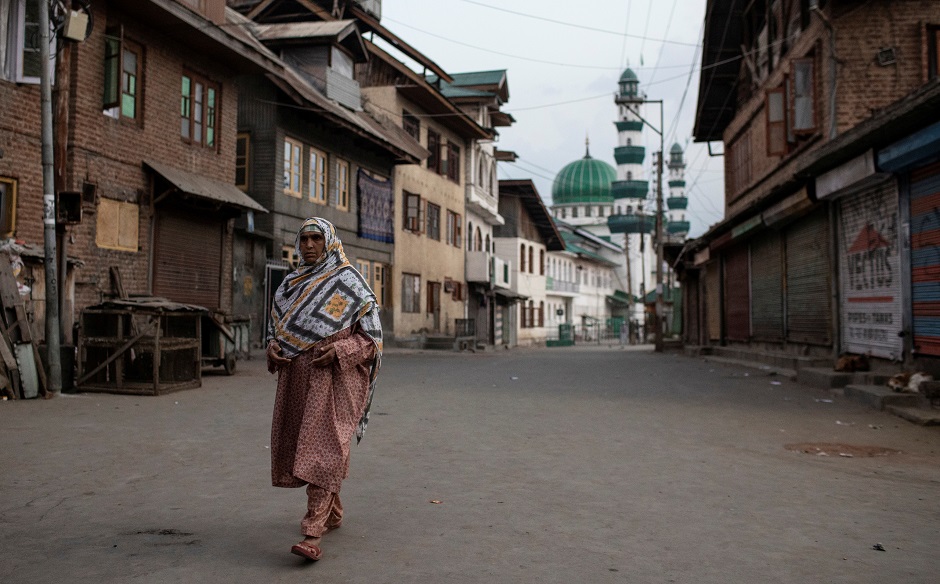 A Kashmiri woman walks through an empty street in Anchar neighbourhood. PHOTO: REUTERS