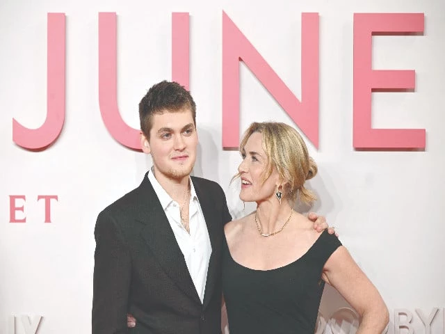 british actress kate winslet poses with her son actor and writer joe anders on the red carpet upon arrival at the premiere of her film goodbye june in central london photo afp