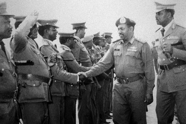 Revolutionary Council ruler and military coup leader General Omar Al-Bashir (C) greets other Revolutionary Council military officers during a graduation ceremony at the Sudanese Military Academy in the capital Khartoum. PHOTO: AFP