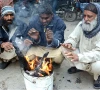people warming their hands in karachi photo app