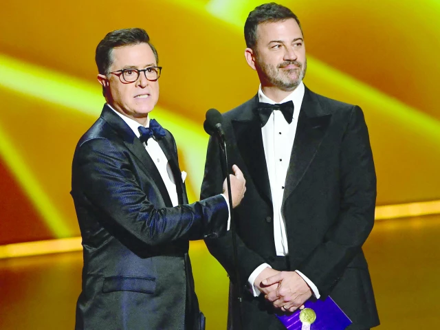stephen colbert and jimmy kimmel speak during the 71st emmy awards at the microsoft theatre in los angeles on september 22 2019 photo afp