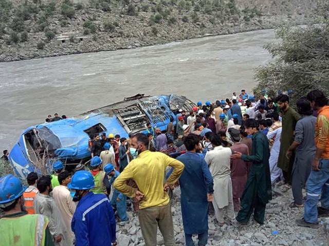 rescue workers and onlookers gather around a wreck after a bus plunged into a ravine following a bomb explosion photo afp